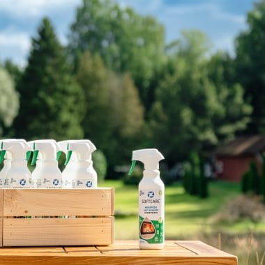 A wooden crate full of soot cleaning products in front of the cottage outdoors