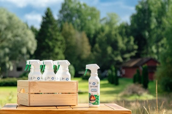 A wooden crate full of soot cleaning products in front of the cottage outdoors