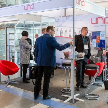 Group of people at the promo display stand at the conference event