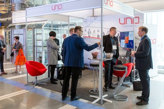Group of people at the promo display stand at the conference event