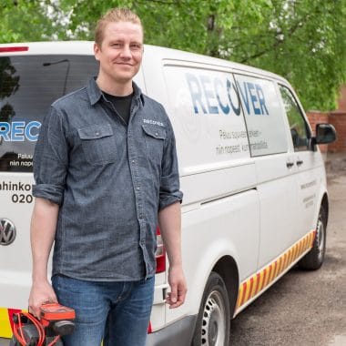 Promo photo of maintenance worker in front of the service car