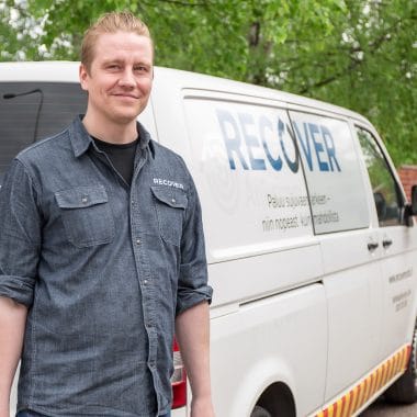 Promo photo of maintenance worker in front of the service car