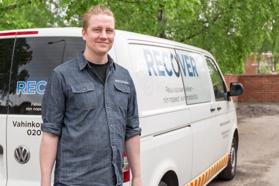 Promo photo of maintenance worker in front of the service car