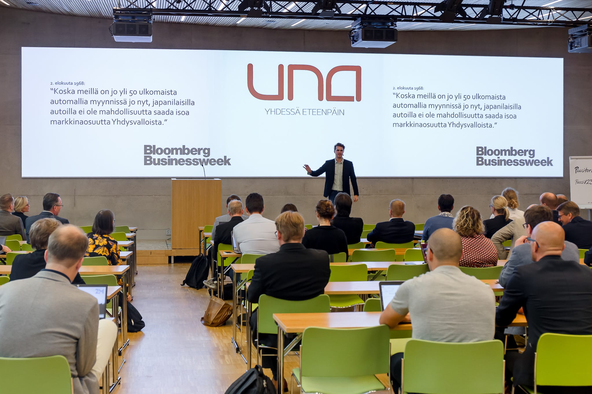 Famous speaker giving a presentation at the conference in front of large audience