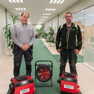Team photo of maintenance service workers and their equipment