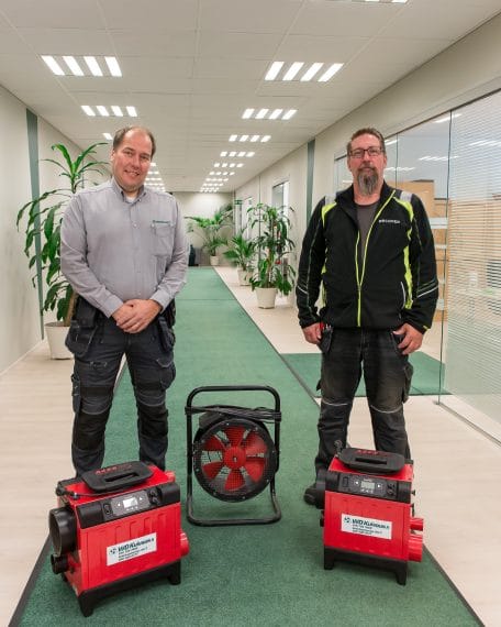 Team photo of maintenance service workers and their equipment