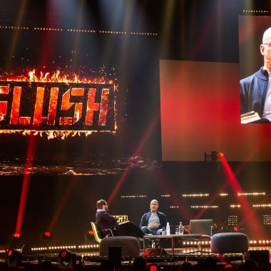 Speaker and the host at the stage of large IT and startup conference