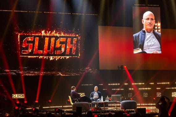 Speaker and the host at the stage of large IT and startup conference
